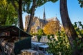 Notre-Dame de Paris cathedral and a typical bookstall by a sunny fall evening Royalty Free Stock Photo