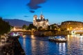 Notre Dame de Paris with cruise ship on Seine river at night in Royalty Free Stock Photo