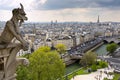 Notre Dame of Paris: Famous Chimera (demon) overlooking the Eiffel Tower at a spring day Royalty Free Stock Photo