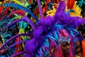 NOTTING HILL, LONDON - AUGUST 27, 2018: Notting Hill Carnival, lots of large feathers on headpiece of woman in parade.