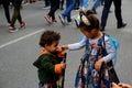 Notting Hill Carnival Mother with smartphone take picture of daughter in carnival costume