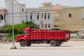 Nouakchott, Mauritania - October 08 2013: Old and classic Coca-Cola truck driving on dirt road in capital