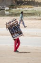 Nouakchott, Mauritania - October 08 2013: Street scene with sunglasses salesman walking down the road