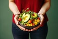 Hands Hold a Bowl of Nutrient-Dense Salad, Highlighting Avocado, Tomato, and an Assortment of Healthy Vegetables