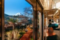 Snow covered Mount Fuji and local town along train route seen through window in Shimoyoshida - Fujiyoshida, Japan