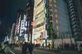 Nov 26 2023 Japan, Tokyo, Ginza, pedestrian traffic in street, dusk Royalty Free Stock Photo