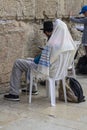 A Jewish man in a prayer shawl with other Jews and general devotees praying at the Western Wall in Jerusalem Israel Royalty Free Stock Photo