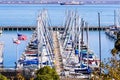 Nov 2, 2019 San Francisco / CA / USA - Boats moored at the South Beach Harbor; the American flag and the California Republic flag Royalty Free Stock Photo