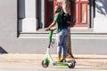 Nov 2, 2019 San Francisco / CA / USA - Young man riding a lime scooter in downtown San Francisco; Lime is the brand name under