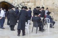 A small group of Hasidic Jews gathered  for prayers, readings and various devotions in a corner of the Western Wall Plaza in Royalty Free Stock Photo