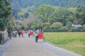 2 Nov 2013 Unidentified man with a rickshaw and tourists at Chikurin-no-michi Royalty Free Stock Photo