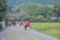 2 Nov 2013 Unidentified man with a rickshaw and tourists at Chikurin-no-michi Royalty Free Stock Photo