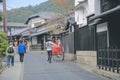 2 Nov 2013 Unidentified man with a rickshaw and tourists at Chikurin-no-michi Royalty Free Stock Photo