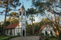 Church with belfry and house in a wooden park