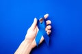 November. Blue ribbon in hands isolated on deep blue background. Awareness prostate cancer of men health in November. Supporting