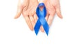 November. Blue ribbon in hands isolated on white background. Awareness prostate cancer of men health in November. Supporting