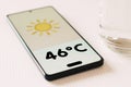 Thermometer showing 46ÃÂºC of heat is displayed on a smartphone screen Royalty Free Stock Photo