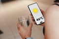 Woman holds a glass of water, the thermometer showing 46ÃÂºC of heat is Royalty Free Stock Photo