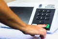 November 16, 2020, Brazil. In this photo illustration a woman simulates a vote in the electronic ballot box used in the elections