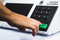 November 16, 2020, Brazil. In this photo illustration a woman simulates a vote in the electronic ballot box used in the elections