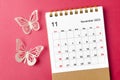 A November 2023 calendar desk for the organizer to plan and reminder with butterfly paer on red background