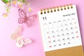 A November 2023 desk calendar for the organizer to plan and reminder and paer butterfly on pink colour background