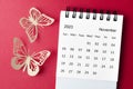 A November 2023 desk calendar for the organizer to plan and reminder with paer butterfly on red background