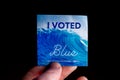 November 3, 2020 - Elkins Park, Pennsylvania: An Election Day Sticker Held by a Hand That Says I Voted Blue With a Wave in the