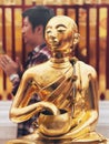 November 2022: Gold statue of Buddha with offering bowl