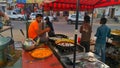 Confectioner making fresh and crispy sweet dish Jalebi outside of the road