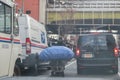 A homeless man is moving his belongs on a mobile cart. in downtown of New York City. Royalty Free Stock Photo