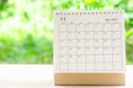November month, Calendar desk 2021 for organizer to planning and reminder on wooden table with green nature background Royalty Free Stock Photo