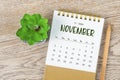 November 2024 monthly desk calendar and pencil with plant pot decoration