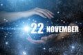 November 22nd. Day 22 of month, Calendar date. Human holding in hands earth globe planet with calendar day. Elements of this image