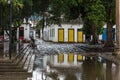 The historical colonial city of Paraty reflected on the water puddles after the rain