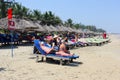 November 2018, People sunbathing sun beds parasols beach, Hoi An, Vietnam