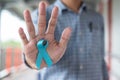 November Prostate Cancer Awareness month, Man in blue shirt with hand holding Blue Ribbon for supporting people living and illness