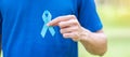 November Prostate Cancer Awareness month, Man in blue T shirt with hand holding Blue Ribbon for supporting people living and