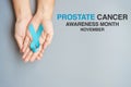 November Prostate Cancer Awareness month, Man holding light Blue Ribbon for supporting people living and illness. Healthcare,