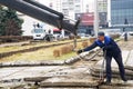 November 6, 2020, Russia, Magnitogorsk. Dismantling and loading of old concrete slabs in the city square. The worker hooks the