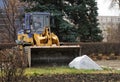 November 6, 2020, Russia, Magnitogorsk. A yellow bulldozer dismantles a huge stone boulder in a city park. Improvement works