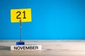 November 21st. Day 21 of november month, calendar on workplace with blue background. Autumn time. Empty space for text