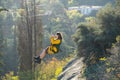 November 05, 2022 Tbilisi Georgia woman tourist tied to steel hawser goes down ropeway over forest