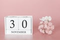 November 30th. Day 30 of month. Calendar cube on modern pink background, concept of bussines and an importent event