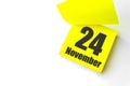 November 24th. Day 24 of month, Calendar date. Close-Up Blank Yellow paper reminder sticky note on White Background. Autumn month