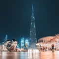 Panoramic view of illuminated Burj Khalifa building at evening. I love Dubai caption with iron heart