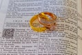 november 04 2016 Wedding rings place on an open Bible to a verse in the book of Genesis marriage. Royalty Free Stock Photo