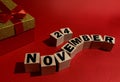 November 24 on wooden cubes on a red background.