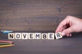 November. Wooden letters on the office desk, informative and communication background