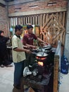 Photo editorial, 27 november 2022, yogyakarta, indonesia, mie godog maker and seller, using charcoal